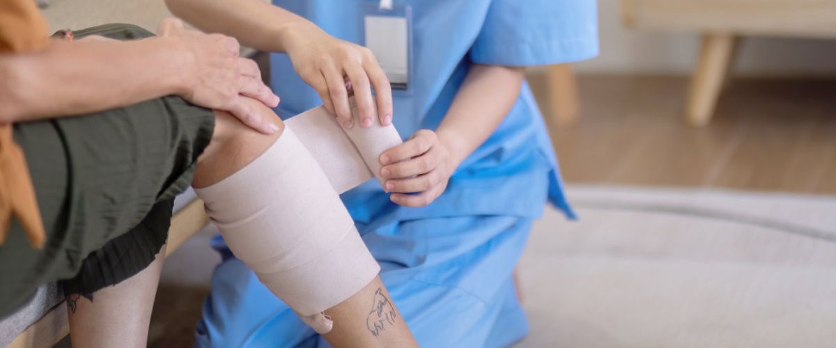 A doctor is wrapping a wound at the clinic.